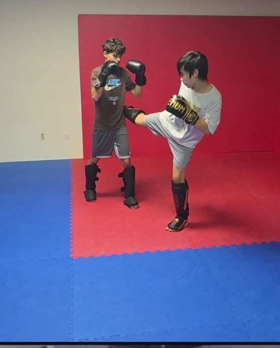 Carlson Gracie Grand Rapids students sparring during kids Muay Thai class.