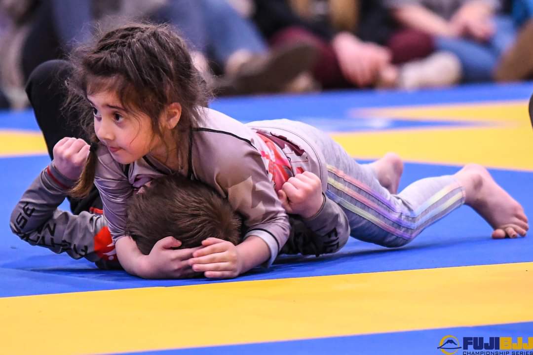 Carlson Gracie Grand Rapids youth wrestling students wrestling on mats during class.