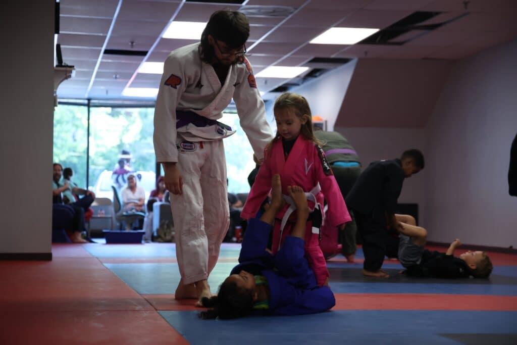 Carlson Gracie Grand Rapids young BJJ students grappling during youth jiu-jitsu class.